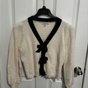 Francesca's Cream Knit Cardigan with Black Trim and Ruffle Front